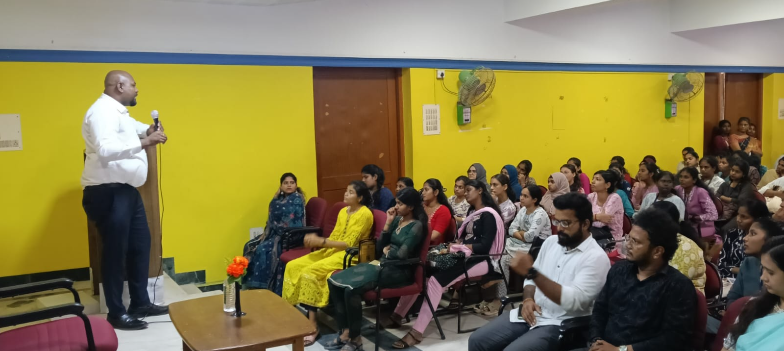 Advocate I. Calvin Jones addressing students during the orientation session at Jain Women's College