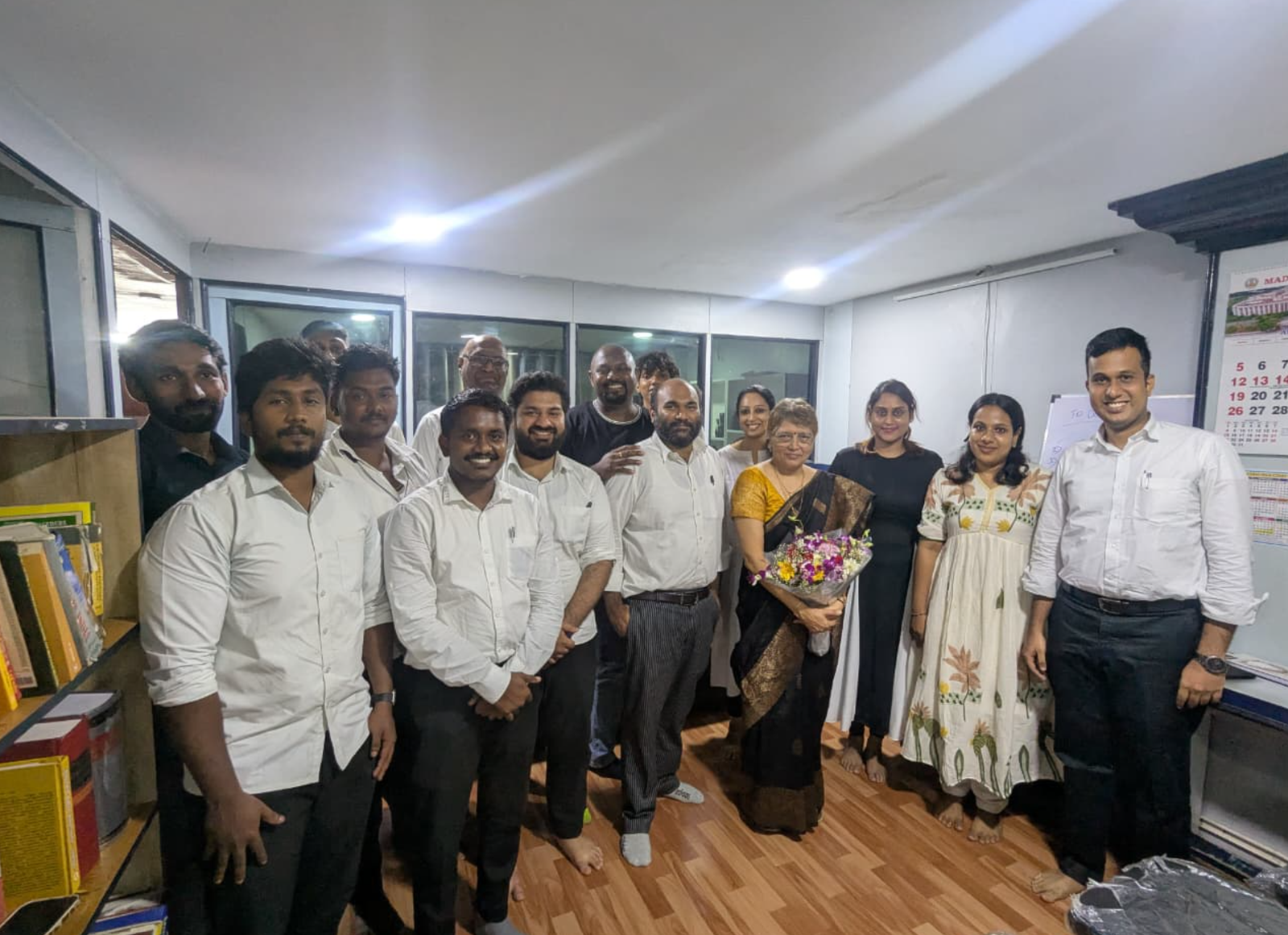 The team welcoming a guest resource person with flowers at a Monthly Academic Session